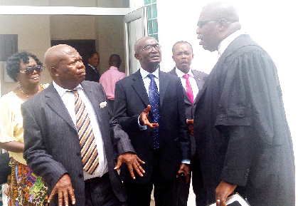 Dr Kwame Amoako Tuffour (left), one of the plaintiffs in the suit, interacting with his lawyer, Mr Egbert Faibille Jnr,