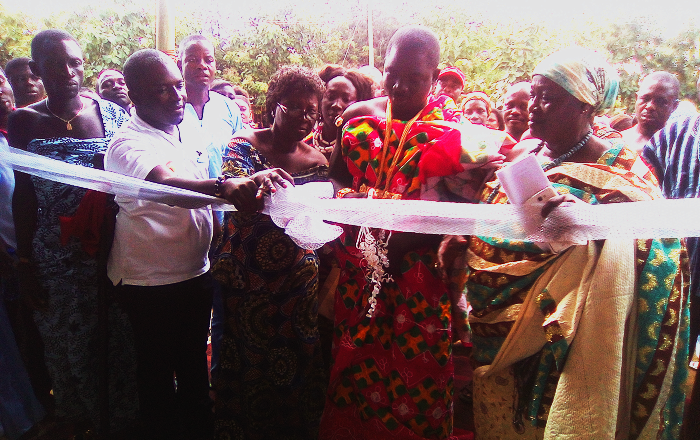  Nana Fianko (2nd right) being assisted by Mrs Esther Amma Bossman (2nd left) and Mr Alistair Djimatey (2nd left) to cut the tape to inaugurate the building 