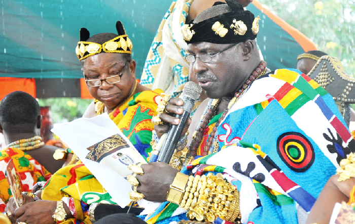 Nene Nornor Sordje V (left), Acting President, Shai Traditional Council reading his speech at the 2016 Ngmayem festival, at the weekend. Picture: SAMUEL TEI ADANO