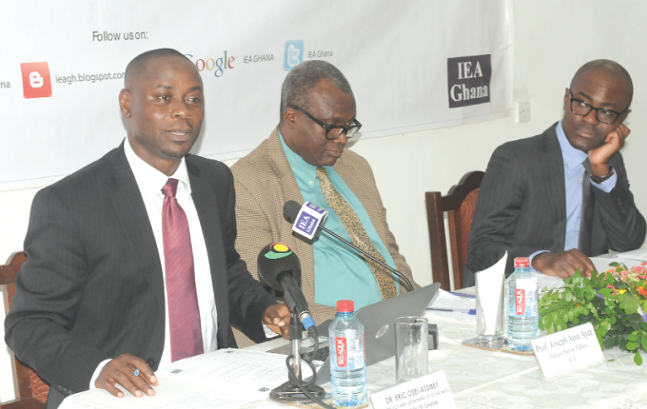 Dr Eric Osei-Assibey (left), delivering his presentation. With him are Dr Micheal Ofori-Mensah (right), Senior Research Fellow, IEA Ghana, and Prof. Joseph Atsu Ayee, Senior Adjunct Fellow, IEA Ghana