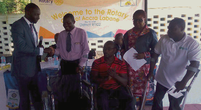  Mr Lamtiig Apanga (left), President, Rotary Club of Accra Labone, in a handshake with Mr Alfred Quarshie, the Regional Secretary of the Ghana Society of the Physically Challenged