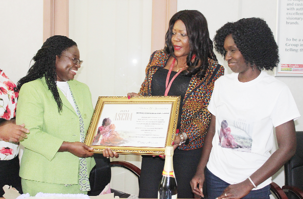 Diana Hopeson(left) presenting a citation to Adwoa Serwaa Bonsu, editor of Graphic Showbiz. Looking on is Bernice Offei