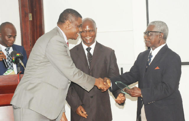 Dr Owen Kaluwa (left), WHO Representative, Ghana, presenting an award to Dr Fred Wurapa (right), Chairman, Certification Committee