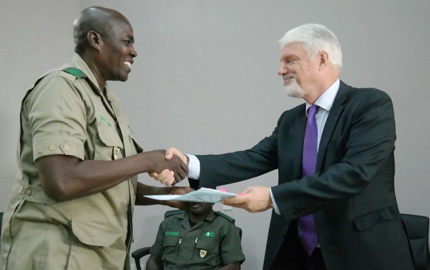 Dr Ben Donkor (left), Executive Director of the Timber Development Division of the Forestry Commission receiving a document from Mr William Hanna, the Ambassador of the EU Delegation in Ghana 