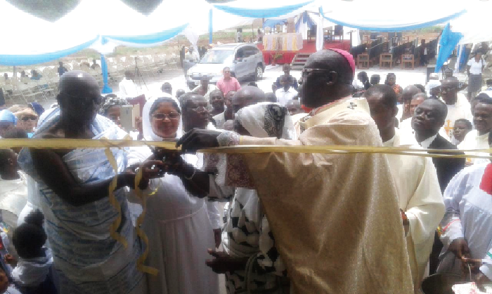 Most Rev. Gabriel Justice Yaw Anokye (right) being assisted by the Odikro of Darban, Nana Adu Gyamfi II (left), the Headmistress, Rev. Sister Suja Alphonsa (middle), and other dignitaries to cut the tape to inaugurate the building (inset)