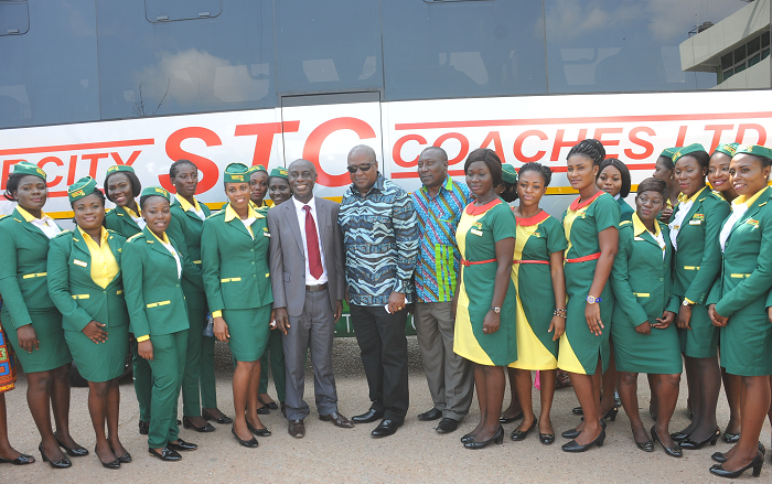 President Mahama (middle) flanked by Mr Patrick Vanderpuye, Board Chairman of STC, and Mr Nuamah Donkor, MD of STC, with some bus stewards. Pictures: EBOW HANSON 