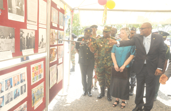  Mr Emmanuel Bombande (right), the Deputy Minister of Foreign Affairs, and Air  Marshal Michael Samson-Oje (2nd left), the Chief of the Defence Staff, at an exhibition mounted at the State House to mark the UN Day celebration in Accra. Looking on are Ms Christine Evans Klock (2nd right), UN Resident Coordinator in Accra, and other officials. Picture: GABRIEL AHIABOR