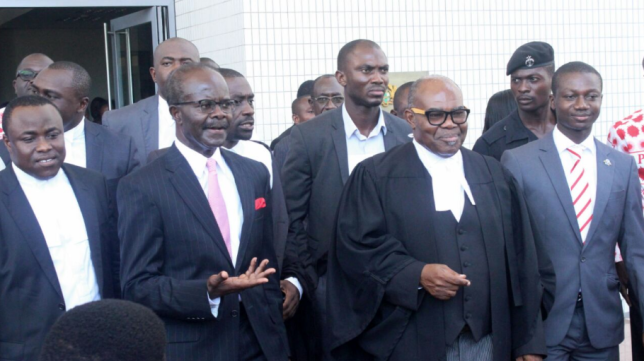 Dr Papa Kwesi Nduom (left), the flag bearer of the PPP together with Mr Ayikoi Otoo (2nd left), his counsel and some PPP supporters and sympathisers leaving the courtroom after proceedings in Accra.