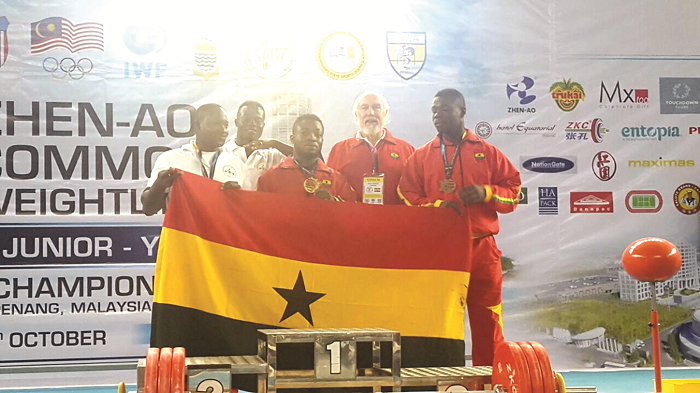 Forrester Osei with the weightlifting coach Dr Kyle Pierce and other members of the Ghanaian contingent at the championship