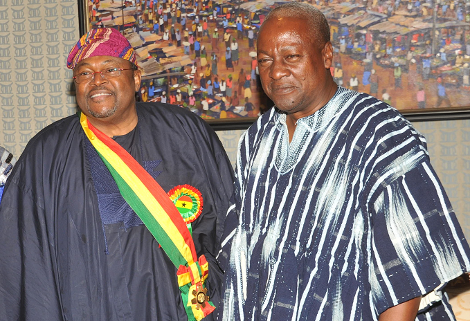 President Mahama in a pose with Dr Mihael Adeniyi Ishola Adenuga Jnr after decorating him with the highest awerd, Companion of the Star of Ghana.