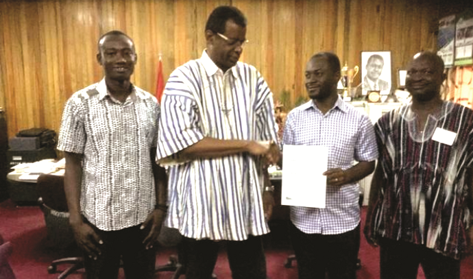   The Vice Chancellor (second left) presenting the certificate to Mr Adjei (second right), while two staff members look on