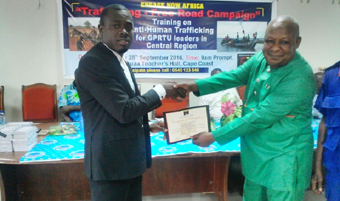  Mr David Kofi Awusi (left) presenting a certificate of participation to Alhaji Artey