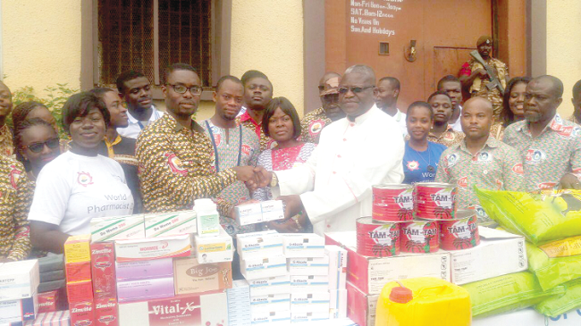 Dr Ekuadzi (2nd left) flanked by colleague pharmacists presenting the items to Rev. Canon Ansah of the Ghana Prisons Service