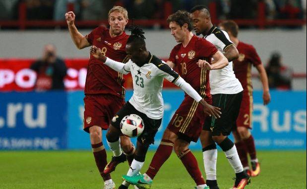 Harrison Afful sandwiched by his Russian markers during the match