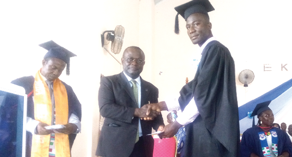 Prof. Ebenezer Oduro Owusu (left) presenting a prize to one of the First Class students
