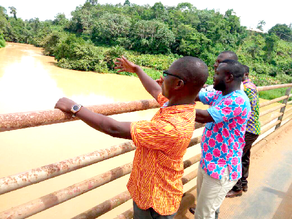 Mr Robert Agyemang Nyantakyi (left), the DCE of Twifo Atti-Morkwa, showing some journalists the improved state of  River Pra. Picture: Timothy Gobah