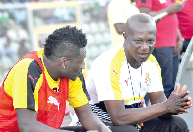 Black Stars coach Kwasi Appiah discussing Sunday’s match with his captain, Asamoah Gyan (left)