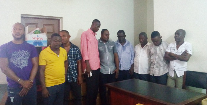 The nine suspects after they had been arrested. Inset: Fake gold bars