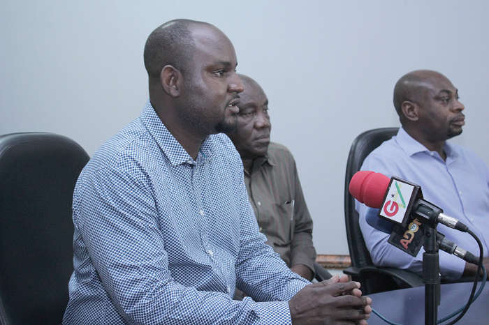 Mr Amenyah (left) answering questions from the media