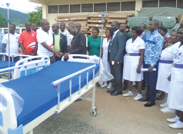 Mr Martin Olu-Davies (fourth left) handing over the beds to the Eastern Regional Minister, Mr Eric Kwakye Darffuor