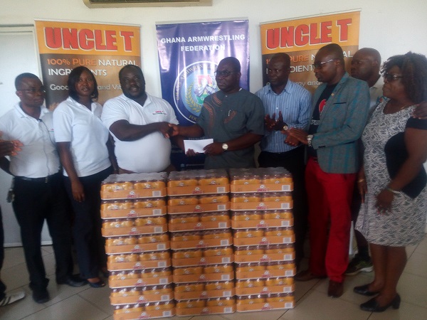 The Sales and Marketing Manager of TT Brothers, Nicholas Nii Addo (in white) handing over the items to the Director of the National Sports Authority Robert Sarfo Mensah.