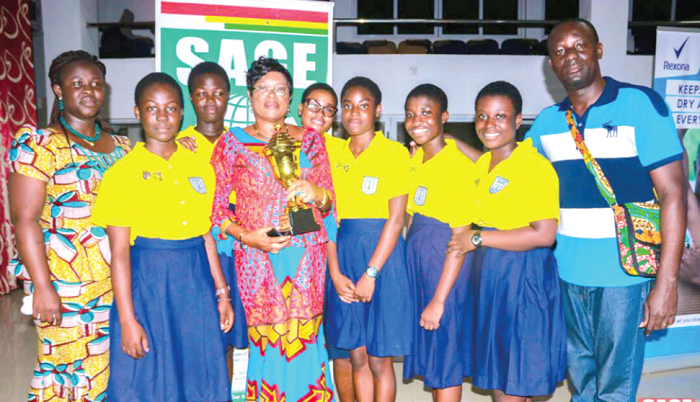 • Ms Sylvia Isabella Laryea, the Headmistress,(with) trophy and participants of the school
