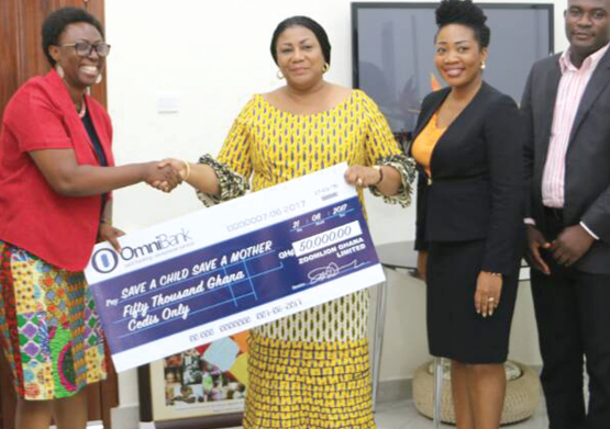 Mrs Rebecca Akufo-Addo (middle) receiving the dummy cheque from Mrs Sophia Lissah (right)