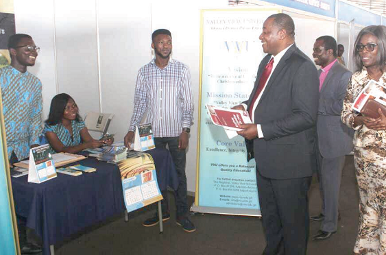 Nana Prof. Osei-Opare K. Darkwa (arrowed), Chairman of Independent Universities, and some council members at one of the exhibition stands