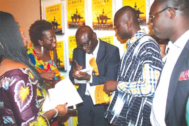 Mr George Yaw Owusu (middle), An Environmental Scientist and Author of In Pursuit of Jubilee autographing some books after the launch. Picture: EDNA ADU-SERWAA 