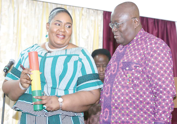 President Akufo-Addo presenting the instrument of office to Mrs Irene Naa Torshie Addo