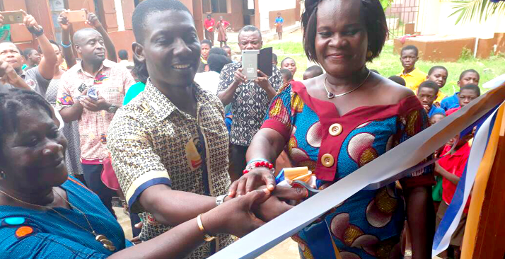   Mr Joe Ampem-Darko Antwi (middle), President of the Rotary Club of Accra Dzorwulu,  being assisted by Ms Joyce Nana Simons (right) the headmistress of Dzorwulu A&B Primary School, to inaugurate the canteen