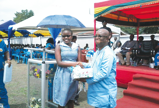  Miss Enyonam Gasu, the overall best student, receiving her prize from Dr Archibald Letsa, Volta Regional Minister 