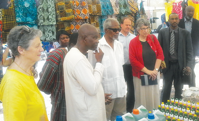 Mr Attah-Antwi (2nd left) explaining a point to Mr Annan (3rd left) at the exhibition