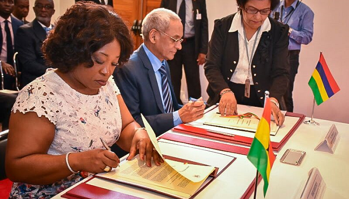 Mrs Shirley Ayorkor Botchway ,Minister of Foreign Affairs and,Regional Integration signing documents at the meeting.