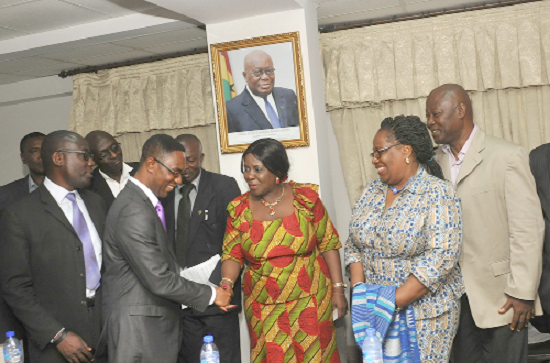  Mrs Cecilia Dapaah (3rd right) in a handshake with Mr Ebo Hammond,  while other members of the Governing Council look on 