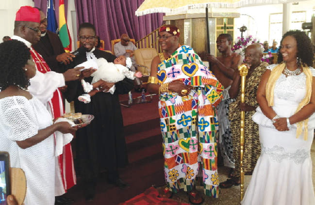 The Minister-in-charge of the Trinity Congregation of the Presbyterian Church of Ghana at Adweso, Koforidua, being assisted by other ministers to pray for Ahenkan, the daughter of Barima Adjei Twinin (in kente) and his wife, Madam Elizabeth Baiden (right)