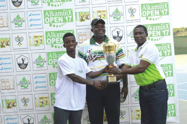  Dr Antwi Tetteh of Rockcare Group presenting the trophy to Ben Fumi, winner of the competition, while Mr Isaac Duah looks on 