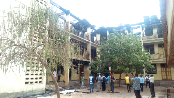 The two-storey domitory gutted by fire. (INSET) The belongings of the students that were salvaged from the inferno