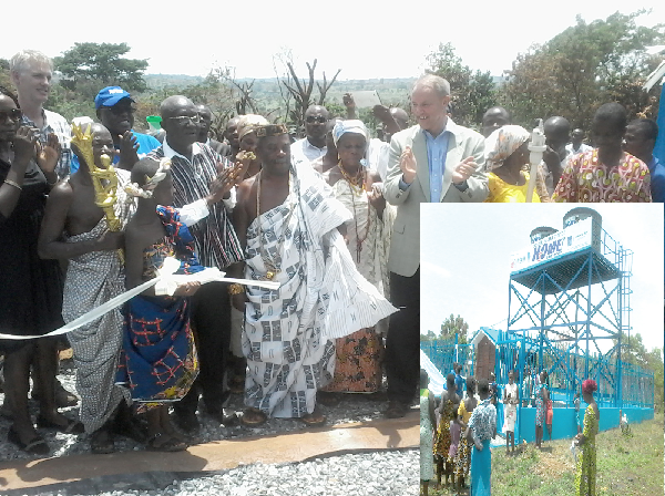Dr Adda (4th left), Mr Strikker (3rd right) and Nene Asafoatse Obotiapong VI (middle) with elders of the town applauding after cutting a tape to inaugurate the water facility