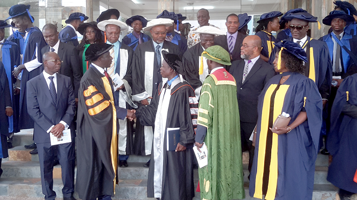 Nana Dwomoh Sarpong (2nd left in front row) in a handshake with Dr Paul Effah