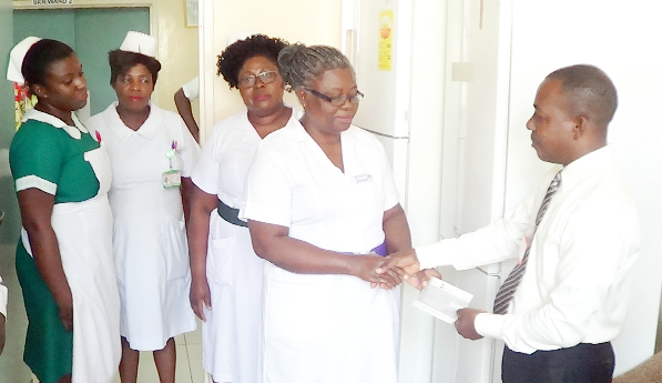 Graphic presents cheque for GH¢4,326 to Korle Bu