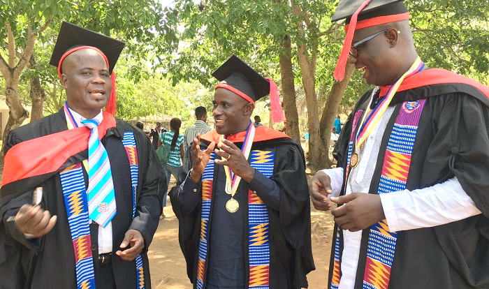 Mr Severious Kale-Dery (middle) shares a joke with Mr Timothy Gobah (left) and Mr Moses Dotsey Aklorbortu after they had successfully graduated with master’s degrees at the University of Cape Coast 