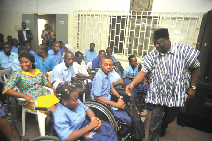  Mr Amoako Atta (standing) interacting with some of the  PWDs in Accra. Pictures: EMMANUEL QUAYE 