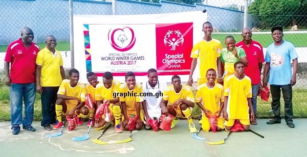 A Board member of Special Olympics Ghana, Nana Wereko- Ampim Opoku, (left) pose with the interllectually disabled floorball team and some officials 