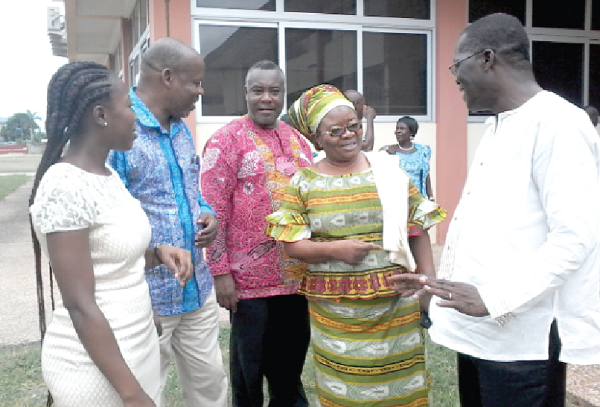  Mr Ben Guri (right), Executive Director of CIKOD, interacting with Madam Victoria Adongo, while Mrs Grace Dzifa Wornyoh (left), and Dr N. Karbo, a former Director of the CSIR and Chairman of the occasion (second left), as well as Mr Willi Laate, Deputy Executive Director of CIKOD (middle), look on