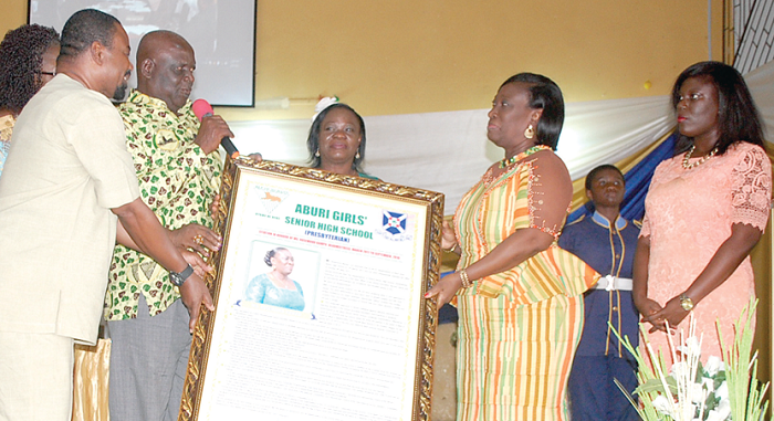  Mr Samuel Donkor Gyan (third left), member of the Board of Governors of Aburi Girls’ SHS, being assisted by Dr Vladimir Antwi Danso, PTA Chairman of the school, and Mrs Alice Prempeh-Fordjour (2nd left), Headmistress of the school, to present a citation to Ms Bampo  