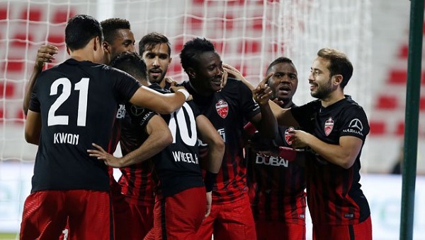 Asamoah Gyan celebrates with Al Ahli teammates