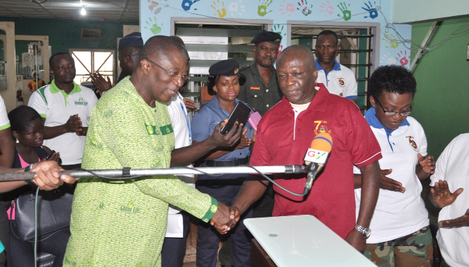 Mr Ivan Avereyireh presenting items to Col. Michael Yeboah Agyepong (right)