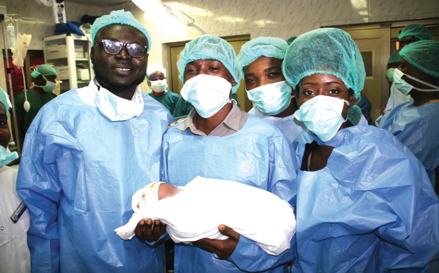 Some journalist with the baby after the operation