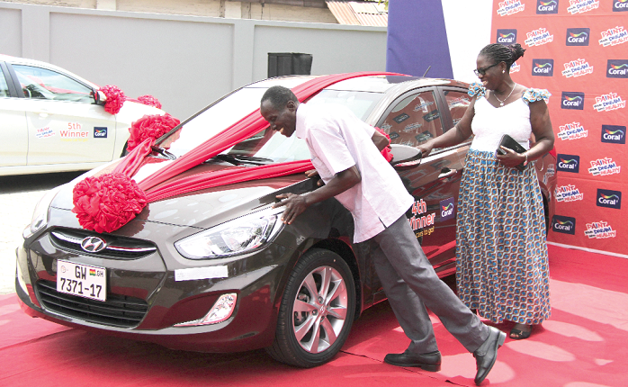 Mr Kwame Badu Baiden and his wife admiring their new car